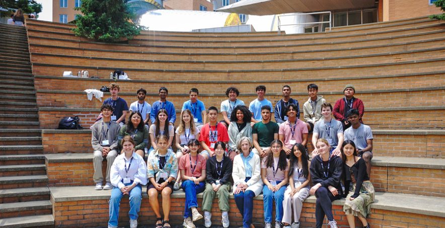 Group of high school students posing for a group photo with MIT President Emerita Susan Hockfield